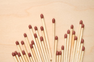 Matchsticks in a row on wooden table.