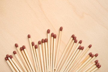 Matchsticks in a row on wooden table.