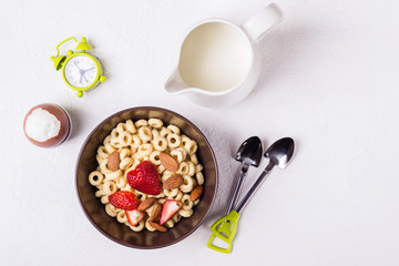 Balanced traditional breakfast. Whole grain rings, berries and egg on white table.