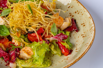 Healthy salad plate. Fresh seafood recipe. mussels, squids and fresh vegetable salad and chips. Healthy food.