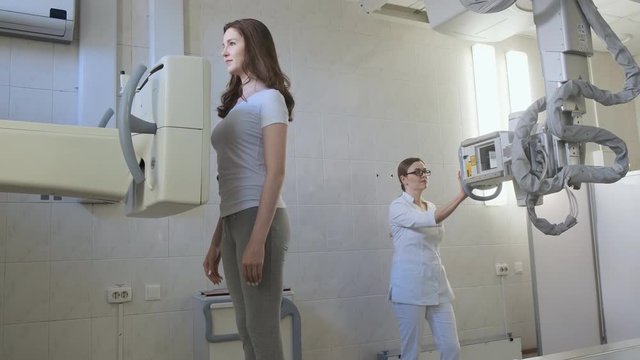 Medical X-Ray Machine In The Hospital Diagnostic Laboratory. Beautiful girl exploring lungs. 4k