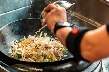 chef preparing food on pan
