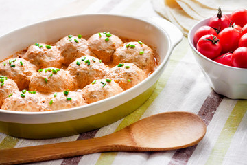 Chacken meatballs baked in creamy tomato sauce