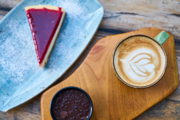 Latte coffee and cheesecake on a table