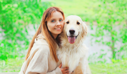 Portrait happy smiling owner woman and Golden Retriever dog together in summer day