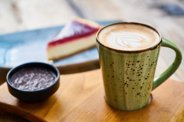 Latte coffee and cheesecake on a table