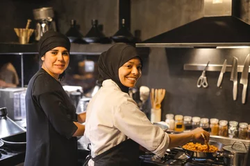 Zelfklevend Fotobehang Two female cooks in a restaurant © olly