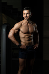 Obraz na płótnie Canvas Serious Bodybuilder Standing In The Gym