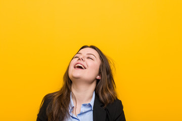 Fototapeta premium Young plus size caucasian business woman relaxed and happy laughing, neck stretched showing teeth.