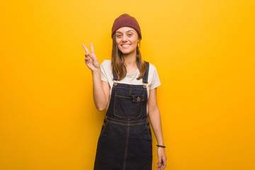 Young hipster woman showing number two
