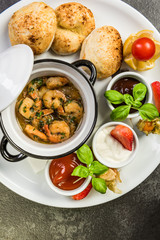 Prawns served on platter with sauces and fresh bread
