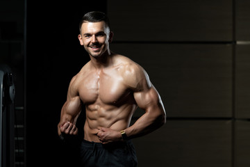 Fototapeta na wymiar Muscular Man Measuring His Muscles