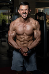 Fototapeta na wymiar Young Man Showing Abdominal Muscle