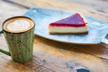 Latte coffee and cheesecake on a table