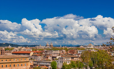 Rome historic center old skyline above Trastevere with old churches, belltowers, domes and clouds, seen from Aventine Hill