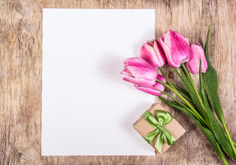 Gift box and tulips. Empty sheet of paper and flowers. Pink tulips
