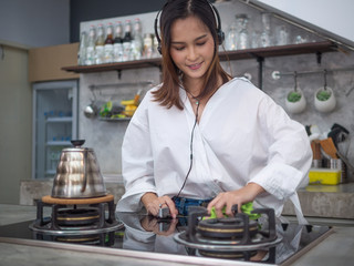 young happy asia housewife enjoy with her cleaning work at home or her coffee cafe