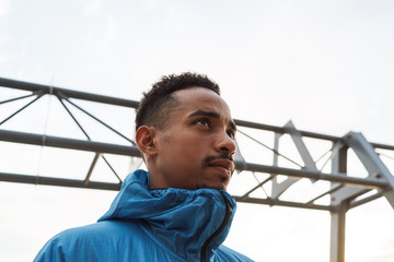 Strong handsome young african sports man outdoors at the beach sea.