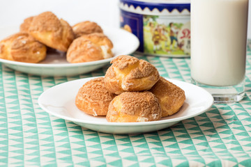 There are delicious puffs and milk on the table
