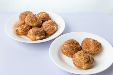 There are delicious puffs and milk on the table