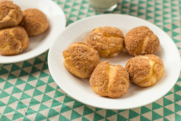 There are delicious puffs and milk on the table