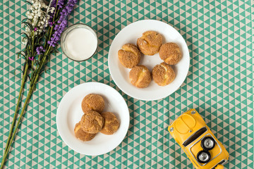 There are delicious puffs and milk on the table