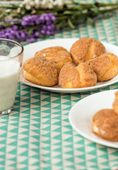 There are delicious puffs and milk on the table