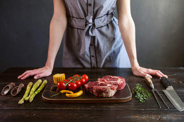 set for cooking a festive dinner for two. two raw marbled beef steaks, spices, vegetables