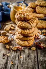 Traditional american baking, homemade Peanut Butter Cookies with peanuts and peanut butter on rustic wooden table