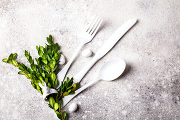 Easter table setting  on on gray background. Holiday decoration.Happy Easter concept. Copy space for Text.