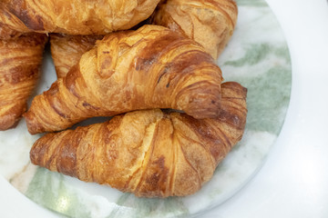 Freshly baked croissants on a marble  board