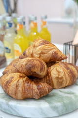 Freshly baked croissants on a marble  board