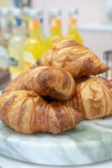 Freshly baked croissants on a marble  board