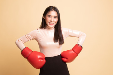 Young Asian woman with red boxing gloves.