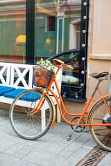 Fototapeta na wymiar Orange bicycles at the entrance to the cafe