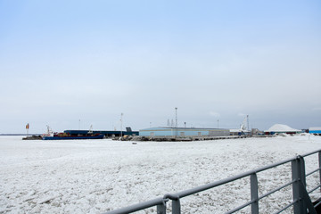 sea ice over frozen or mini Glacier with snowy . person standing on an ice raft on icy sea shore During travel at Helsinki , Vaasa in winter Finland .
