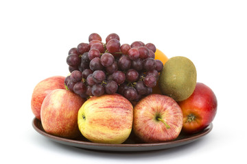 Naklejka na ściany i meble fresh fruits on a plate on white background