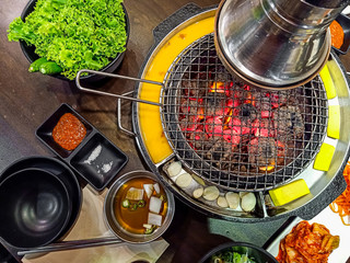 Grill and mesh grill of charcoal fire ( Bulgogi ).Table set of korean barbecue, meat , pork,...