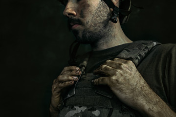 Holding on for last forces. Close up portrait of young male soldier. Man in military uniform on the war. Depressed and having problems with mental health and emotions, PTSD, rehabilitation.