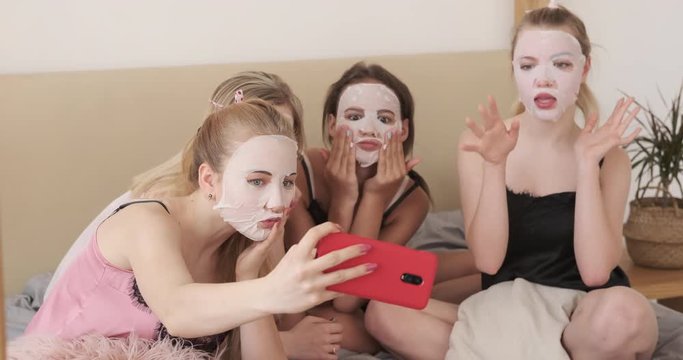 Teen girls applying moisturizing facial tissue mask