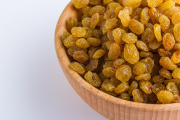 golden raisins on a white acrylic background