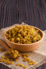 golden raisins on a wooden rustic background