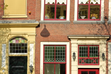 Fototapeta na wymiar Close-up on a historical facade with carvings, located along Oude Delft Canal, Delft, Netherlands