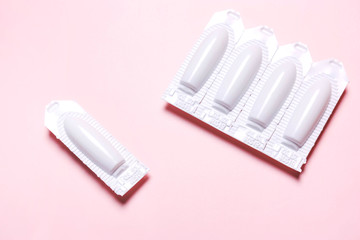 suppository on a pink background, for the treatment of hemorrhoids, vaginal  candidiasis