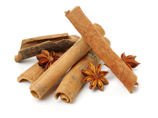 Cinnamon and anise on white background