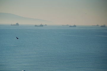 Cargo ships waiting to enter the Novorossiysk port in foggy weather