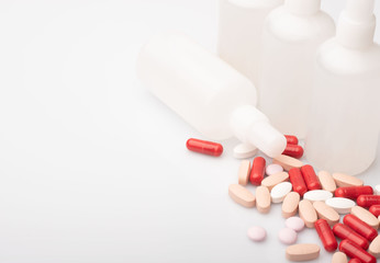 medical red and white pills and capsules with medicine are on a white background