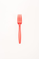 red plastic bright fork isolated on white