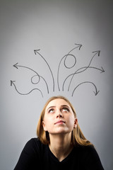 Frustrated young woman in thoughts. Arrows over her head.