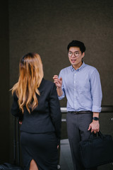 A few colleagues discussing work before they return home. They look alluring in their office clothing.